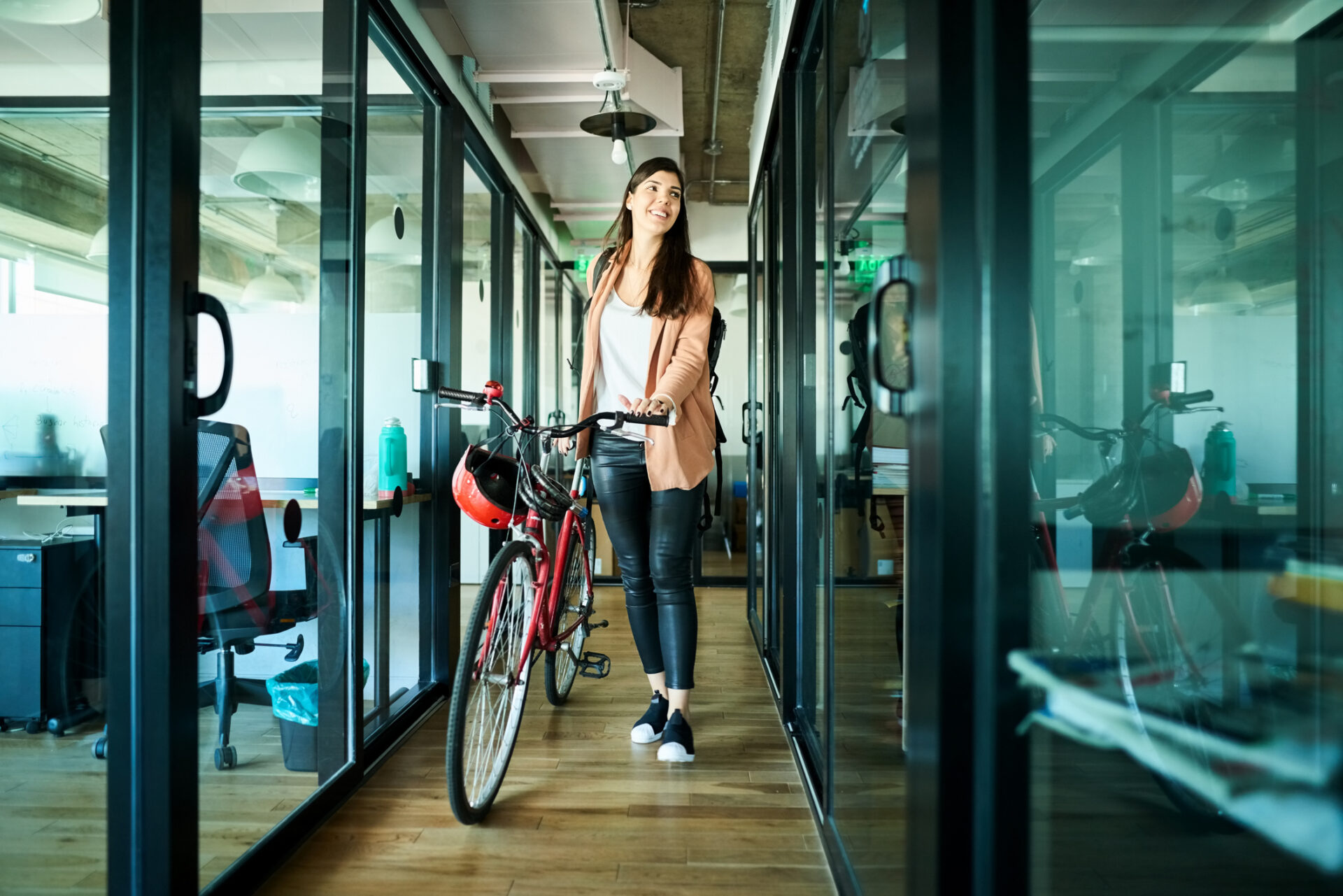 businesswoman arriving to work on bike