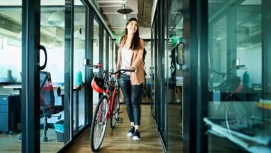 businesswoman arriving to work on bike