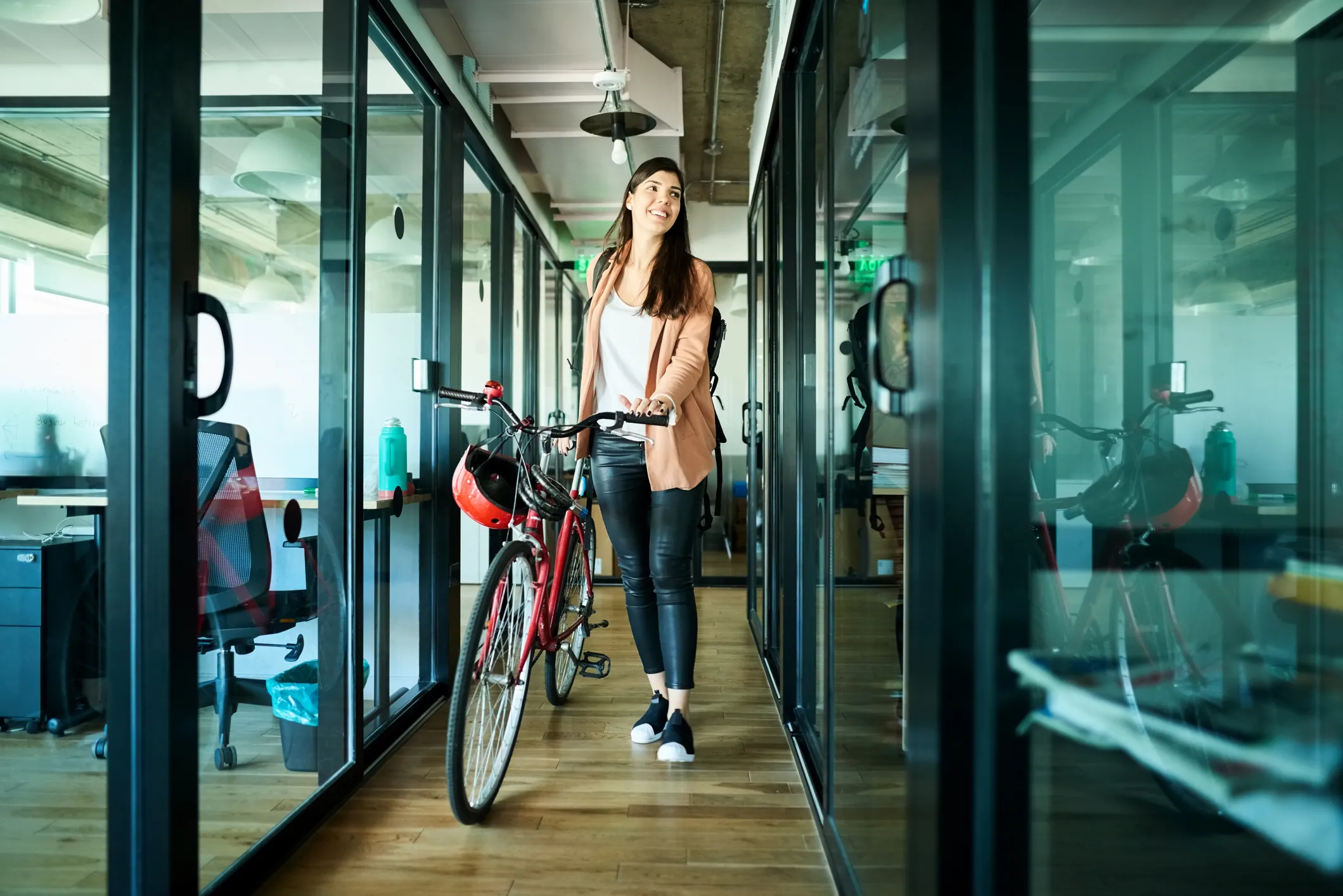 businesswoman arriving to work on bike