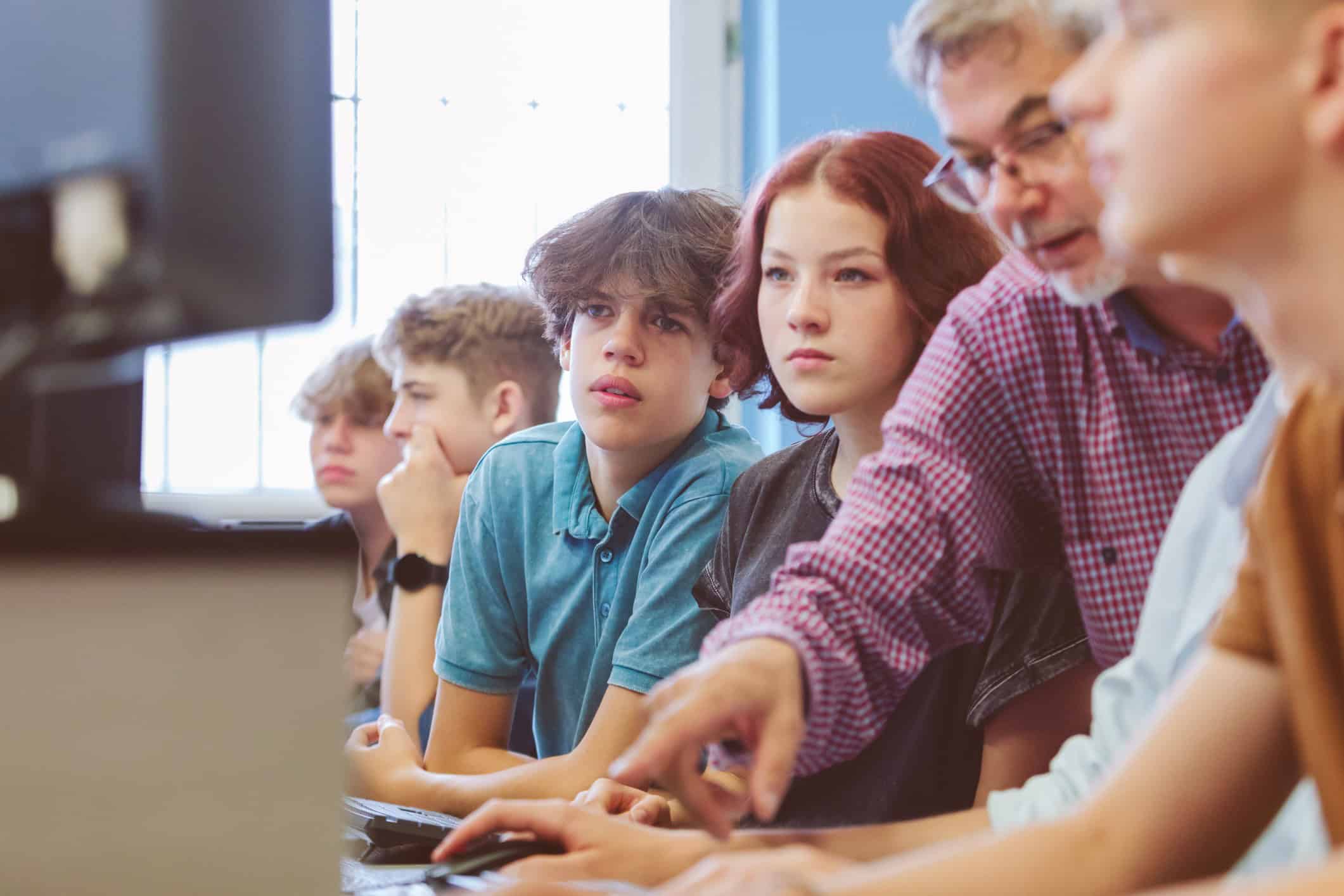 group of high school students learing programming