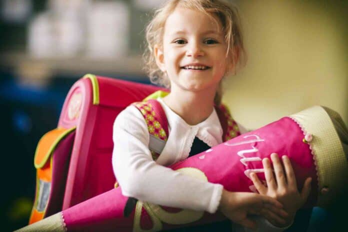 schoolgirl first day in school cone education child